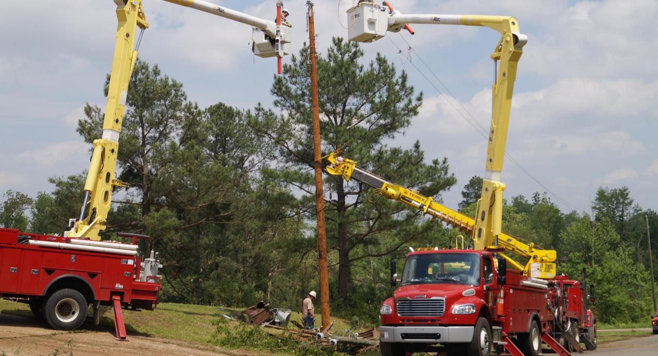 Utility trucks replace broken pole